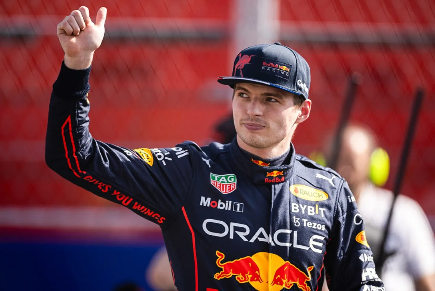 Max Verstappen celebrates his victory in the Spanish Grand Prix, proudly standing beside his Red Bull Racing RB13 car.