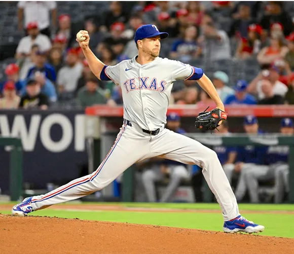 A baseball player in action, skillfully throwing a pitch on the field during a game.