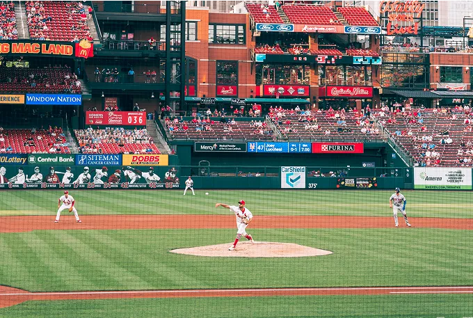 A baseball game in progress, featuring players on the field and spectators in the stands, capturing the excitement of the sport.