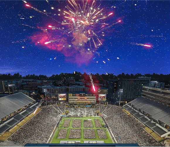 A vibrant stadium filled with a large crowd, all gazing up at a spectacular display of colorful fireworks.